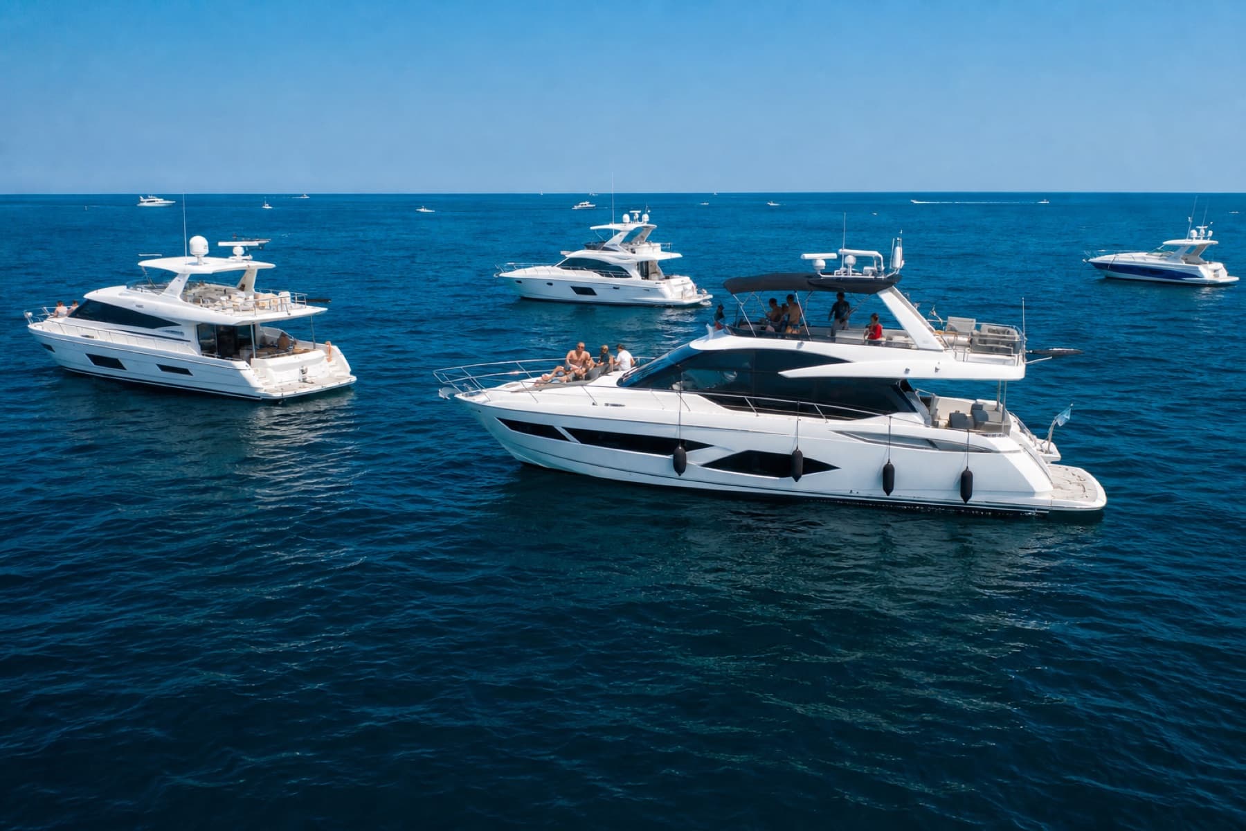 Premium yachts gathered on blue water at The Playpen
