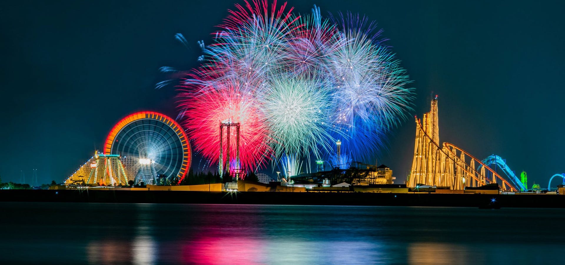 Fireworks over a waterfront amusement pier